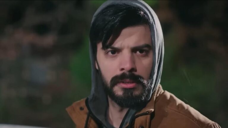 Volkan z naciągniętym na głowę kapturem.