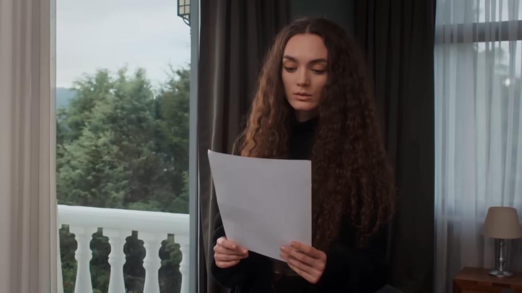Nana patrzy na napisany przez siebie list.