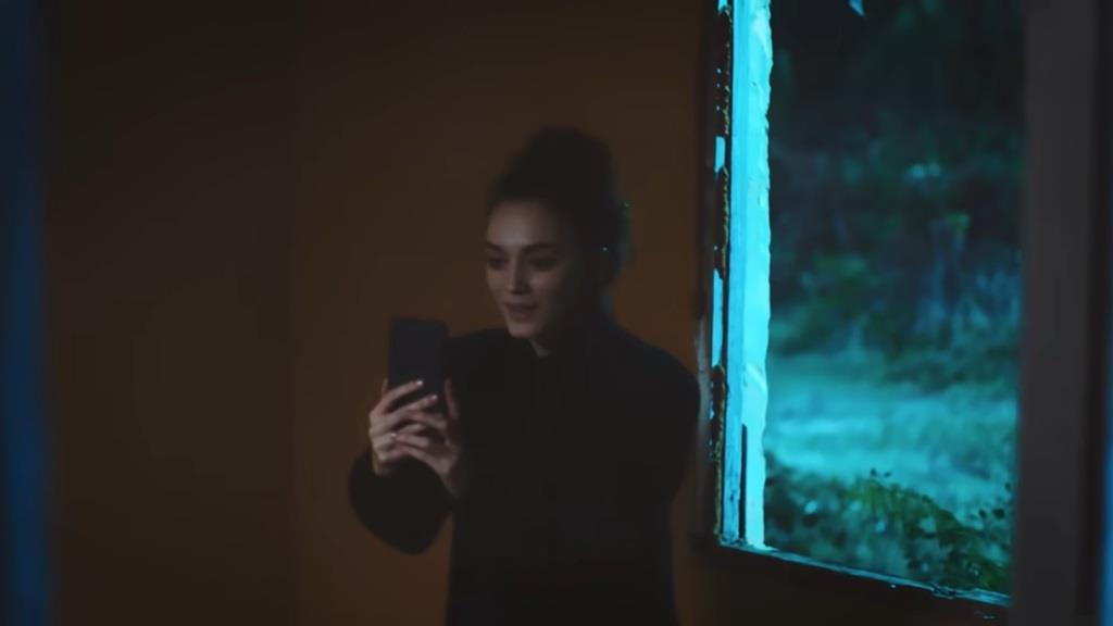 Nana z radością wpatruje się w ekran telefonu, odbierając wideorozmowę.