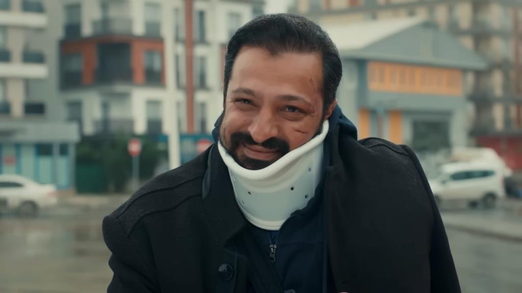 Zbliżenie na twarz Idrisa w gorsecie ortopedycznym.