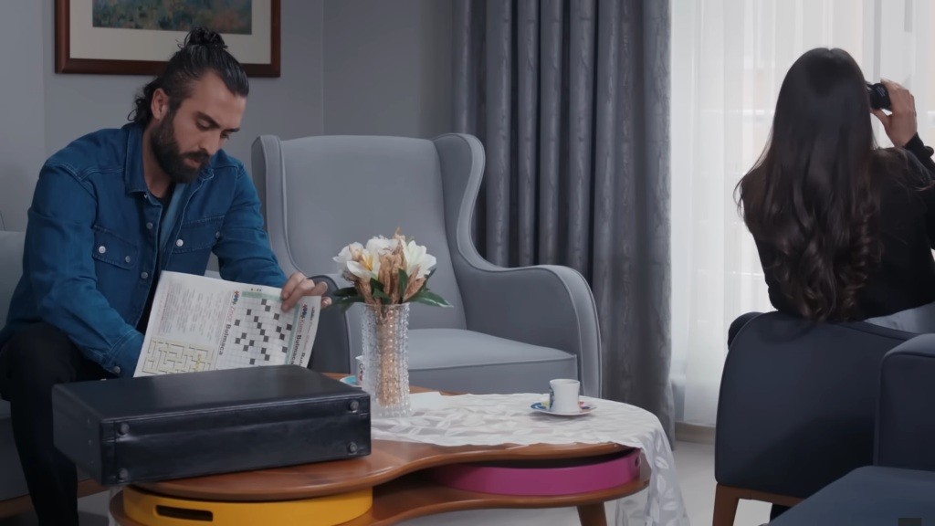 Ayse siedzi przy oknie, prowadząc obserwację, a Ferit szkicuje jej portret.