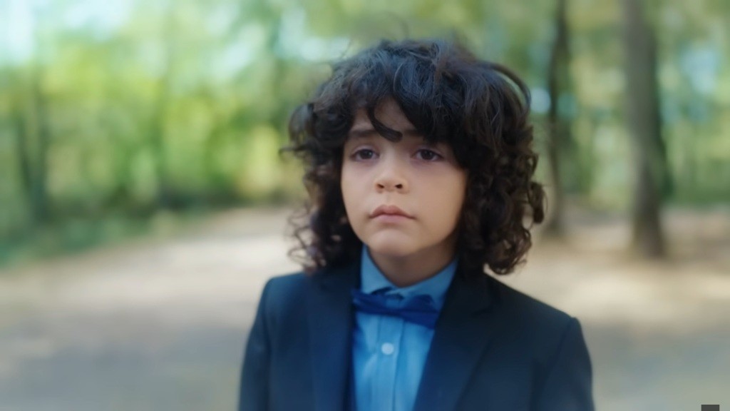 Yusuf ubrany w garnitur.