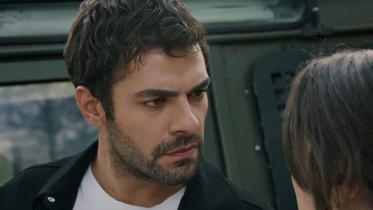 Halil patrzy na Zeynep, stojąc przy samochodzie.