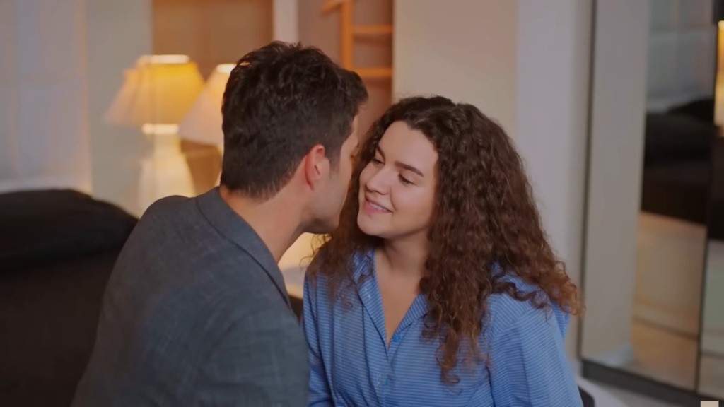 Melis uśmiecha się, gdy Ege zbliża do niej twarz.