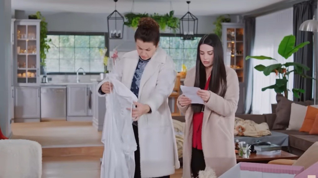 Bahar czyta list, a Cavidan ogląda białą sukienkę.