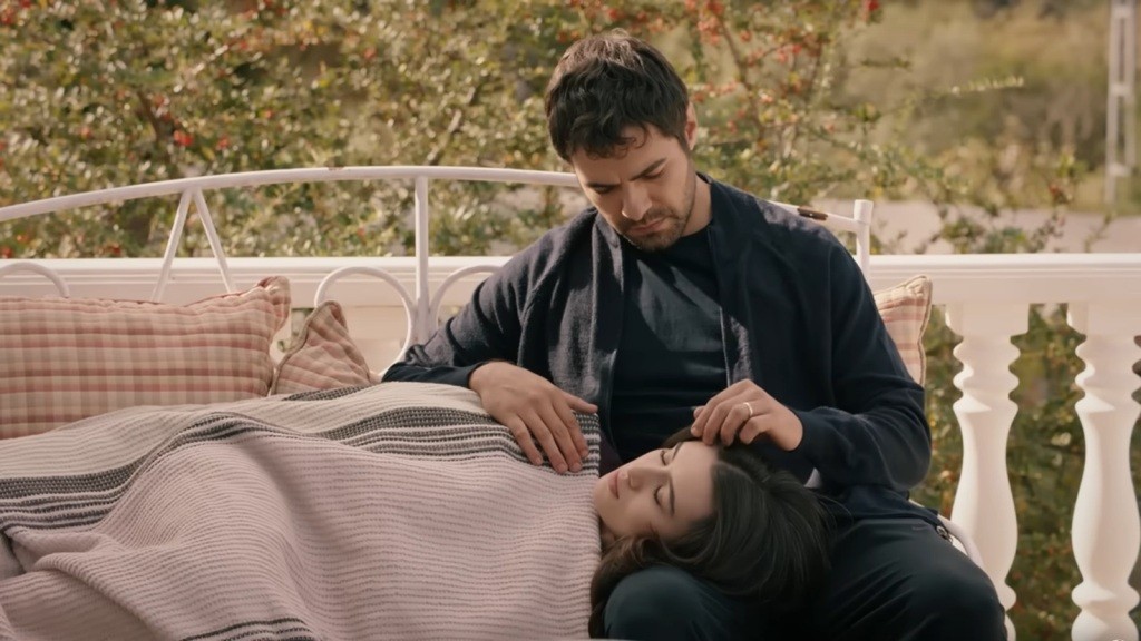 Zeynep zasnęła z głową na kolanach Halila. Mężczyzna delikatnie dotyka jej włosów.