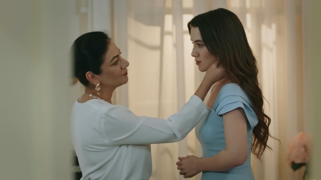 Tulay podziwia kolczyki córki, odgarniając jej włosy.