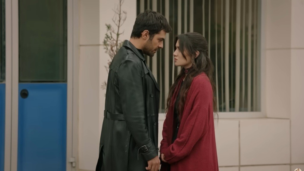 Halil trzyma Zeynep za ręce, stojąc z nią twarzą w twarz.