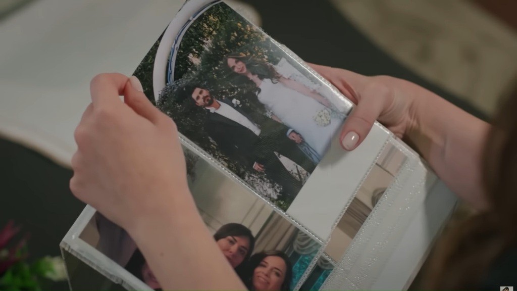 Beyza wyciąga zdjęcie ślubne z albumu.