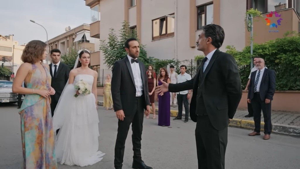 Kazim podchodzi do Abidina z wyciągniętą ręką. Obok stoi Suna w sukni ślubnej.