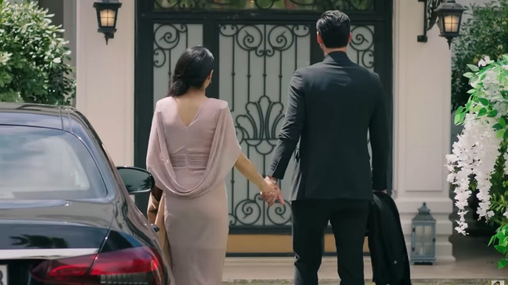 Cihan i Hancer stoją przed wejściem do rezydencji, trzymając się za ręce.