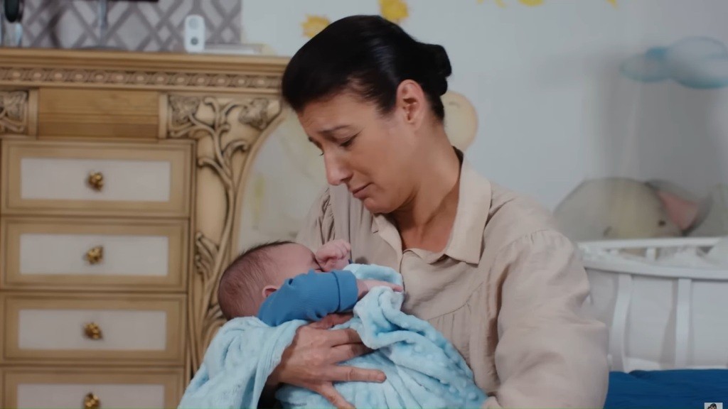 Fadime trzyma Cihana Gurura na rękach. Dziecko owinięte jest w błękitny kocyk.